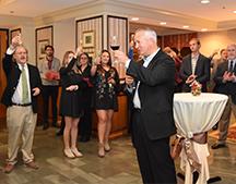 Attendees toast 60th anniversary of LIttle Dinner Series.